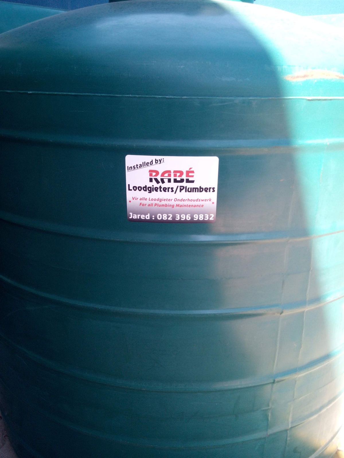 Installed by Rabé Plumbing sticker on a water tank